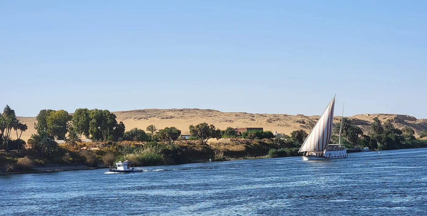 A traditional dahabiya sailing boat on the Nile at sunset