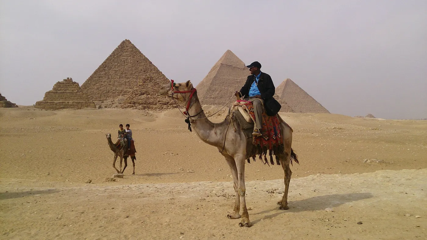 A family exploring the Giza plateau near the pyramids