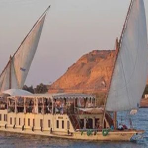 Egypt, Nile River, Dahabiya ship, luxury, vacation, history, culture, natural beauty, Nebyt Dahabiya, deluxe, cabins, sundeck, hot tubs, dining, cuisine, onboard facilities, excursions, activities, ancient temples, Nubian villages, felucca rides, guides, unforgettable experience.