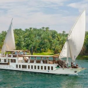 Egypt, Nile River, Dahabiya ship, luxury, vacation, history, culture, natural beauty, Nebyt Dahabiya, deluxe, cabins, sundeck, hot tubs, dining, cuisine, onboard facilities, excursions, activities, ancient temples, Nubian villages, felucca rides, guides, unforgettable experience.