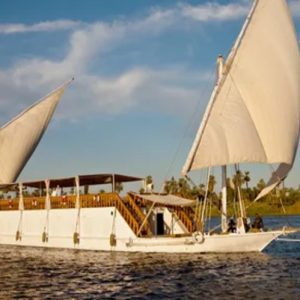 Egypt, Nile River, Dahabiya ship, luxury, vacation, history, culture, natural beauty, Nebyt Dahabiya, deluxe, cabins, sundeck, hot tubs, dining, cuisine, onboard facilities, excursions, activities, ancient temples, Nubian villages, felucca rides, guides, unforgettable experience.