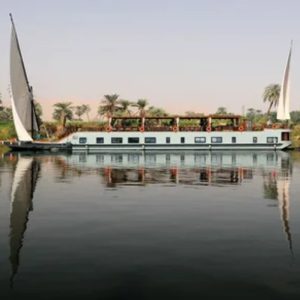 Egypt, Nile River, Dahabiya ship, luxury, vacation, history, culture, natural beauty, Nebyt Dahabiya, deluxe, cabins, sundeck, hot tubs, dining, cuisine, onboard facilities, excursions, activities, ancient temples, Nubian villages, felucca rides, guides, unforgettable experience.