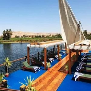 Egypt, Nile River, Dahabiya ship, luxury, vacation, history, culture, natural beauty, Nebyt Dahabiya, deluxe, cabins, sundeck, hot tubs, dining, cuisine, onboard facilities, excursions, activities, ancient temples, Nubian villages, felucca rides, guides, unforgettable experience.