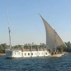 Egypt, Nile River, Dahabiya ship, luxury, vacation, history, culture, natural beauty, Nebyt Dahabiya, deluxe, cabins, sundeck, hot tubs, dining, cuisine, onboard facilities, excursions, activities, ancient temples, Nubian villages, felucca rides, guides, unforgettable experience.