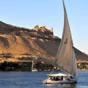 Egypt, Nile River, Dahabiya ship, luxury, vacation, history, culture, natural beauty, Nebyt Dahabiya, deluxe, cabins, sundeck, hot tubs, dining, cuisine, onboard facilities, excursions, activities, ancient temples, Nubian villages, felucca rides, guides, unforgettable experience.